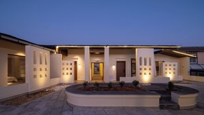 A modern building with a flat roof, large windows, and a well-lit entrance. - Bandu Oxygen Supply Homestay (Deqin)