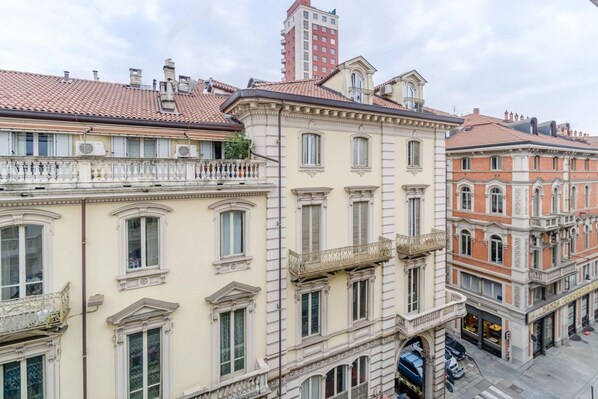 A multi-story building with classic European architecture, featuring balconies and large windows.