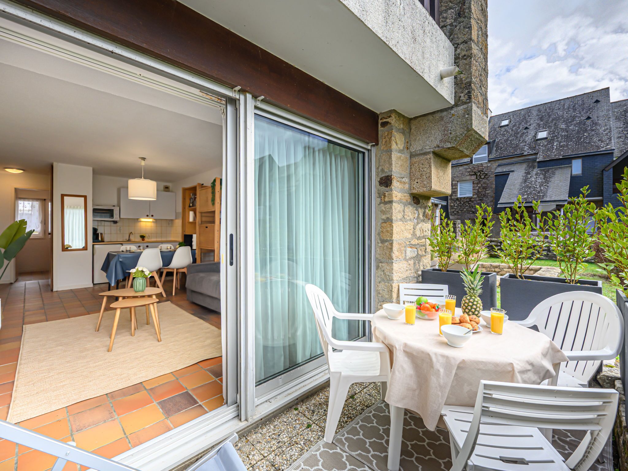 A modern apartment with a balcony, a dining area, and a kitchen.