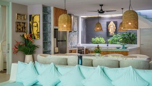 A modern kitchen with a central island, pendant lighting, and a seating area with cushions. - 5 Star Villa with 5 Bedrooms, Bali Villa 2178 (Bali)