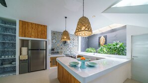 A modern kitchen with a central island, stainless steel appliances, and decorative lighting. - 5 Star Villa with 5 Bedrooms, Bali Villa 2178 (Bali)