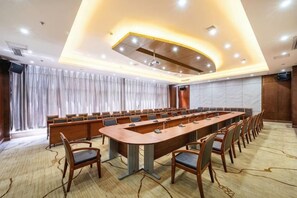 A conference room with a long table, chairs, and a projector screen. - Tianlu Hotel (Shangnan)