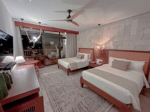 A hotel room with two beds, a desk with a lamp, a ceiling fan, and a view of the balcony. - Hotel Mundo Maya Tulum (Tulum)