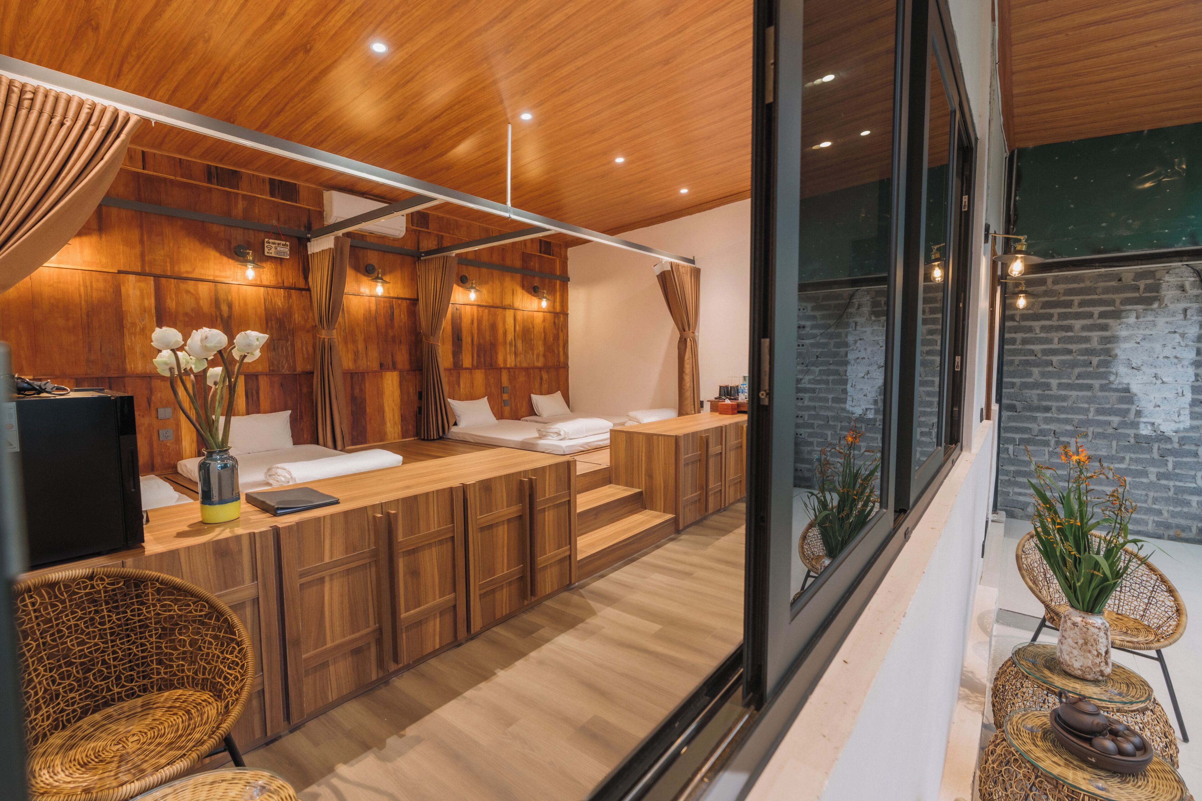 A modern bathroom with wooden cabinetry, a built-in bench, and a large mirror.