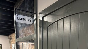 A room with a bed, a laundry sign, and a door. - Livie’s Loft
Trendy loft on Main Street (Sardis)
