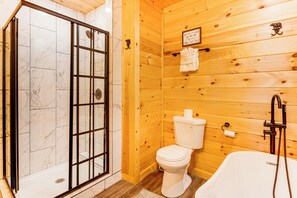A wooden cabin bathroom with a shower, toilet, and bathtub. - Creekside Cabin w/ Hot Tub: 7 Mi to Pigeon Forge (Sevierville)