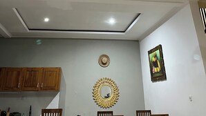 A ceiling fan with four blades, recessed lighting, wooden cabinets, a decorative mirror, and a framed picture on the wall. - Wira Krisna Tranquil Villas by EPS (Ubud)