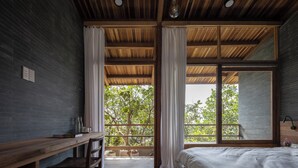 A bedroom with a large window, a wooden desk, and a bed. - Hachi Homestay & Spa (Hue)