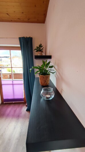 Relax in a serene space with a view of the outdoor area, featuring a wooden ceiling and a window with a view.