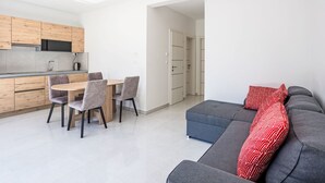 A modern apartment with a dining area, kitchen, and living space. - Sunny Pool by Interhome (Trogir/Okrug Gornji)