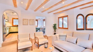 A modern living room with a sofa, two armchairs, a coffee table, and a dining area in the background. - Modern villa with swimming pool and sea views in Denia (Denia)
