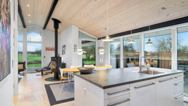 A modern kitchen with a large island, white cabinetry, and pendant lighting. - "Erlinda" - 600m from the sea by Interhome (Humble)