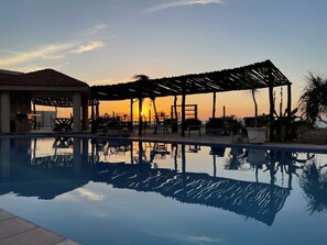 Outdoor pool, open 8:00 AM to 8:00 PM, pool umbrellas, sun loungers