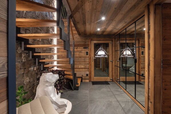 A wooden interior with a staircase, a reception area, and a modern design.