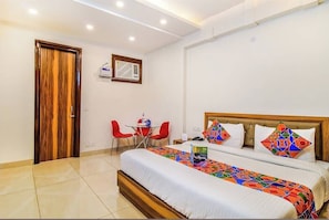 Relax in a stylish room with a large bed, separate seating area, and modern amenities.