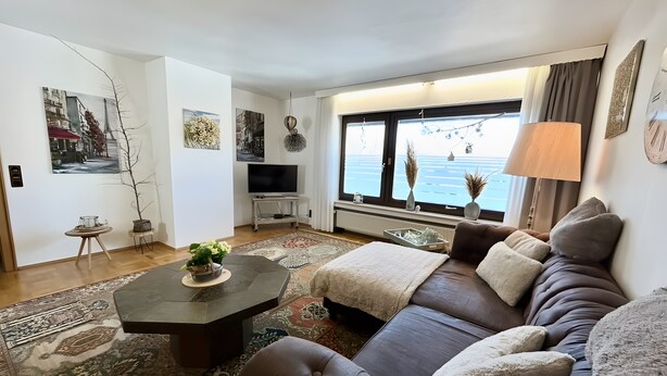 Una sala de estar moderna con un sofá, una mesa de centro y un televisor.