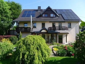 A two-story house with a balcony, solar panels, and a garden. - Apartment 'Börner' with Mountain View and Wi-Fi (Frauenstein)