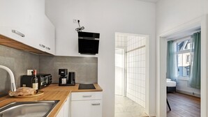 A modern kitchen with a built-in oven, a coffee maker, and a toaster.