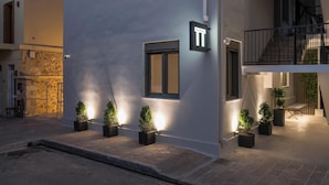 A modern building with a balcony, potted plants, and a sign indicating a suite property. - Pi Suite Project Smart Living (Chania)