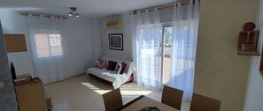 Cozy retreat with a comfortable bed, small table, and chair, offering a peaceful space to unwind.