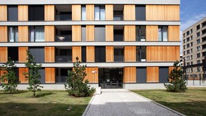 A modern multi-story building with a flat roof, large windows, and a central entrance. - Blueground | Prague 7, furnished with balcony (PRG-1) (Prague)
