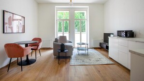 A modern kitchen with a dining area, a sofa, and a coffee table.