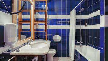 A bathroom with a sink, toilet, and bathtub.