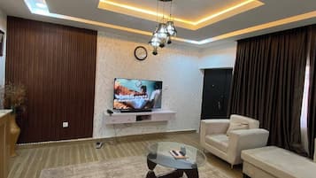 Family Apartment, Balcony, City View | Living area | Flat-screen TV