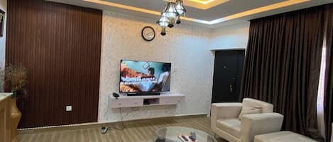 Family Apartment, Balcony, City View | Living area | Flat-screen TV