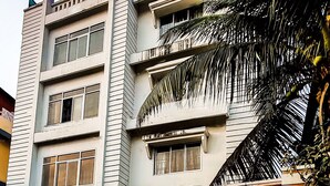 A multi-story building with a sign reading "SPECTRUM PRESIDENCY." - Hotel Spectrum Residency (Guwahati)