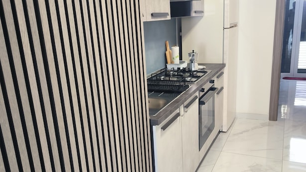 A modern kitchen with a gas stove, oven, and a built-in microwave. - BLUE SEA..... YOUR DREAM VACATION! (Avola)
