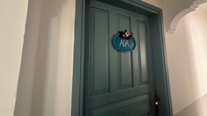 A teal door with a nameplate that reads "ADA" and a floral decoration. - Avşa Çakır Apart (Marmara)