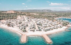 Beachfront villas offer access to the sandy beach and turquoise waters.