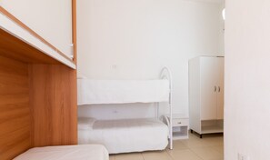 Cozy sleeping space for two, featuring a bunk bed arrangement and simple, functional design.