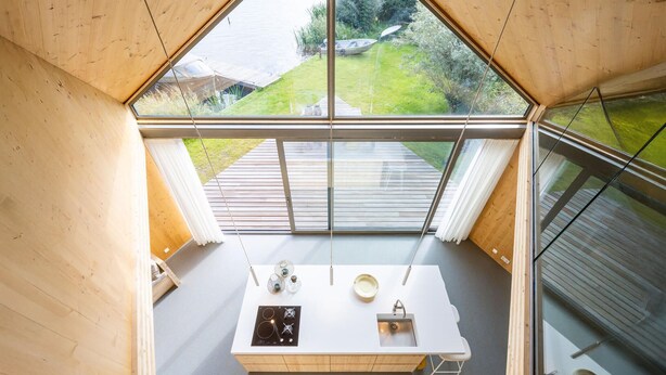 A modern kitchen with a large window, a white countertop, and a view of a garden. - 3 bedroom lovely home in Warten (Warten)