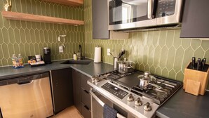 A modern kitchen with a stainless steel stove, microwave, and dishwasher. - Sosuite NEW 2BR Apt w W D Split Level (Philadelphia)