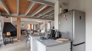 A modern kitchen with a stainless steel refrigerator, a coffee maker, and a kettle on the counter. - House with an extension for 11 at 800m from the sea (La Plaine-sur-Mer)