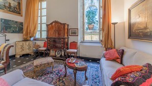 A traditional room with a sofa, armchair, and a wooden cabinet. - Portello Apartment By Geco Vacation Rentals (Genoa)