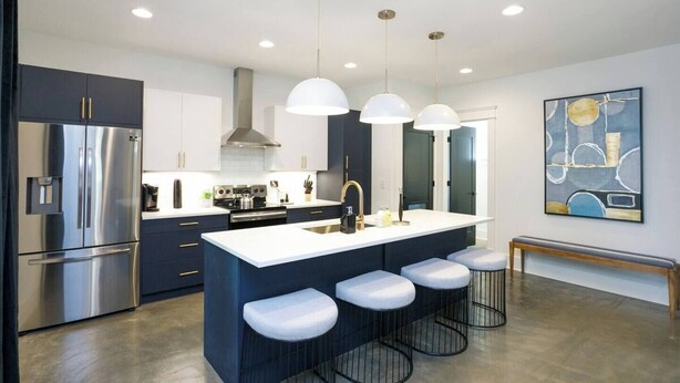 A modern kitchen with a central island, stainless steel appliances, and pendant lighting. - Belmont Luxe | Walk to Hillsboro, Belmont & 12 So (Nashville)