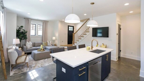 A modern kitchen with a central island, built-in appliances, and pendant lighting. - Chic Belmont Retreat | Walk to Hillsboro & 12 South (Nashville)