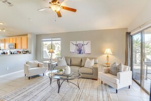 Relax in this inviting living space with a sofa set, coffee table, and kitchenette.