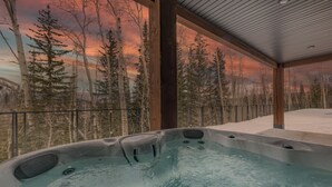 A hot tub with a view of a forest and a sunset. - Modern Ski-in/out Home in Brian Head w/ Deck (Brian Head)