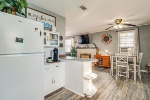 A modern kitchen with white cabinetry, a Midica refrigerator, and a breakfast bar. - 'Louisiana Roots' Home 3 Mi to Dtwn West Monroe! (West Monroe)