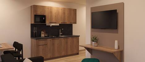 A modern kitchen with wooden cabinets, a black countertop, and a built-in oven. There is a dining area with a table and chairs, and a TV mounted on the wall.