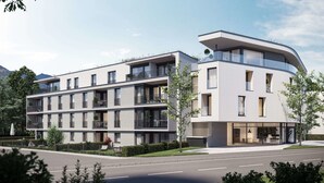 A modern multi-story hotel with balconies, large windows, and a flat roof. - Apartments by Simmerlwirt (Woergl)