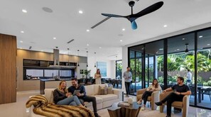 A modern living room with a sofa, coffee table, and a dining area with chairs.