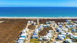 An aerial view of a coastal residential area with houses and a beach. - Amazing Beach Views~Boardwalk to Beach~Shared Pool (Port Aransas)
