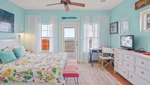 A bedroom with a bed, a desk, a television, and a ceiling fan. - Amazing Beach Views~Boardwalk to Beach~Shared Pool (Port Aransas)