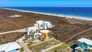 A coastal property with multiple buildings, a beach view, and a pier. - Amazing Beach Views~Boardwalk to Beach~Shared Pool (Port Aransas)