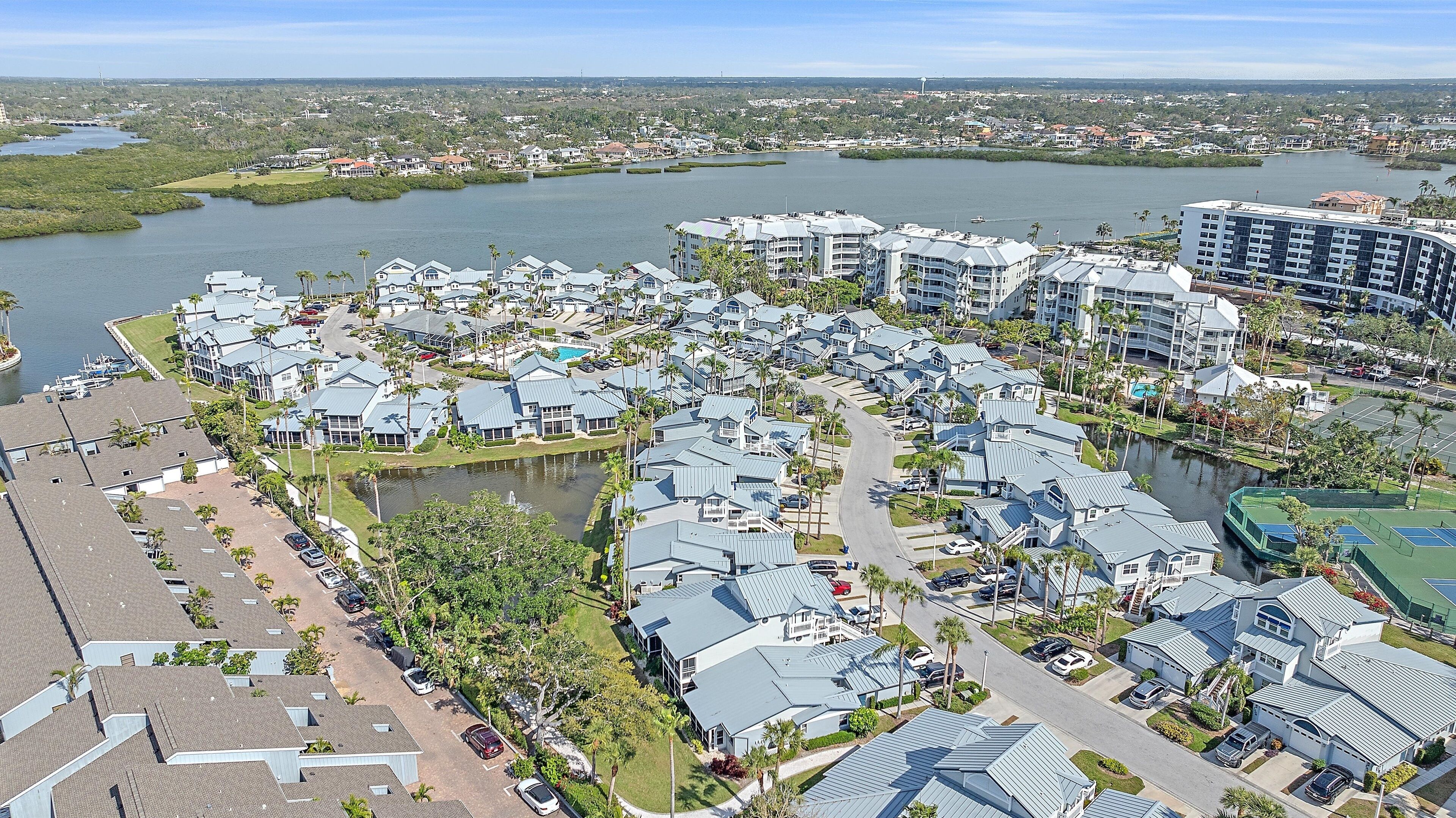 A residential area with houses and a large body of water.